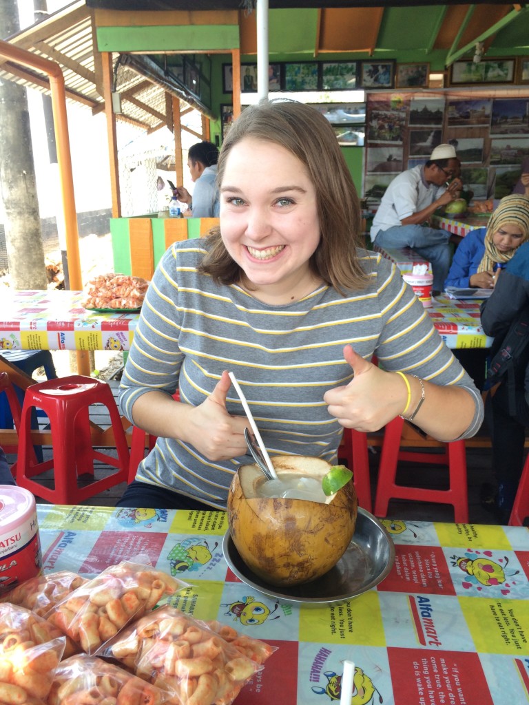 Drinking lime coconut juice out of a coconut