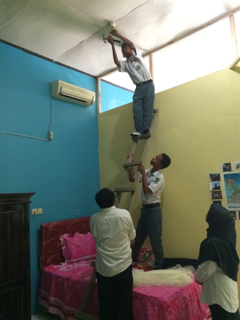 Bought a mosquito net in Bandung and my coteacher recruited some of my students to help put it up