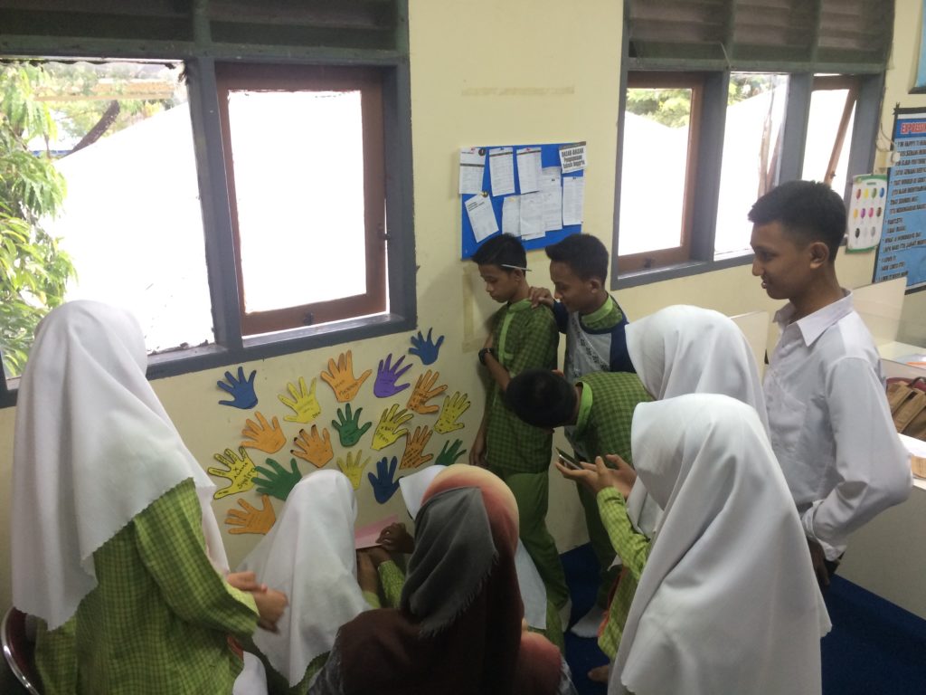 Everyone pitching in to decorate the wall! 