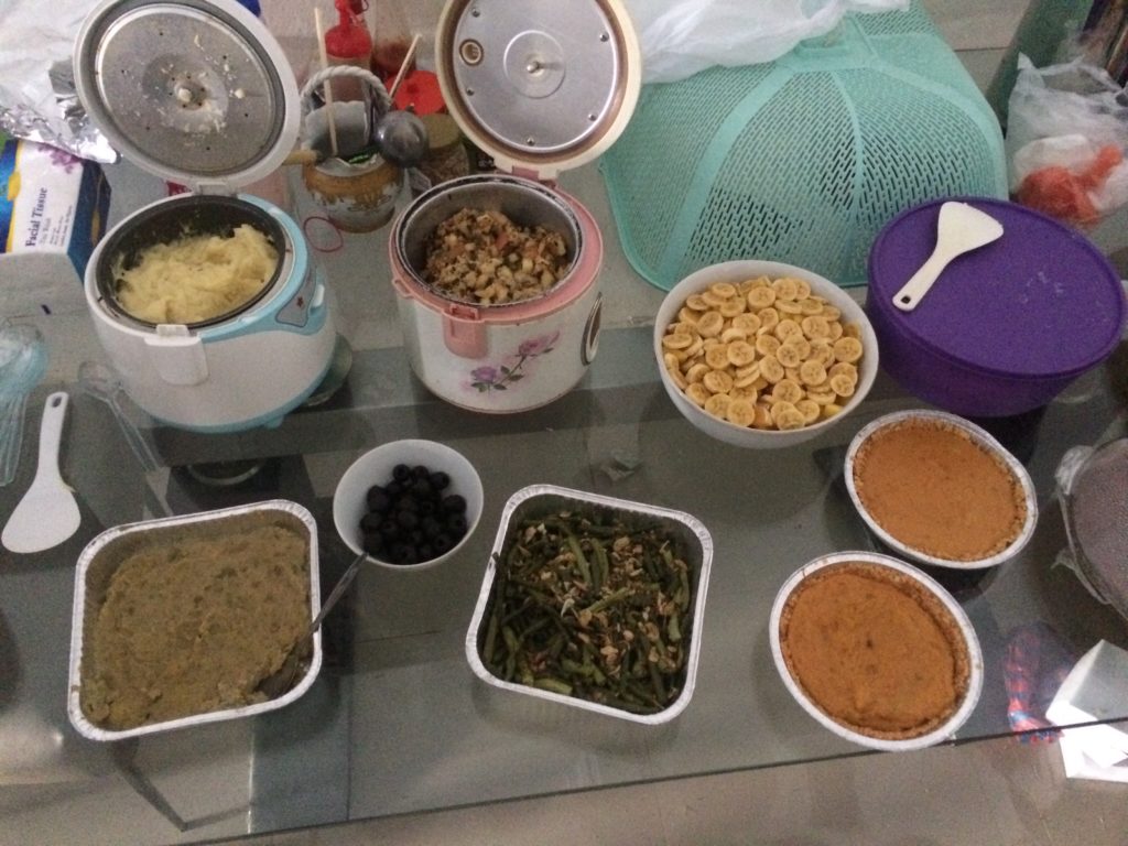 Rice Cooker 1: Creamy Garlic Mashed Potatoes. Rice Cooker 2: Stovetop Stuffing. Large Bowl: Fruit Salad. Left Square Pan: Interesting-looking Sweet Potatoes. Second Pan: Garlic Green Beans. And two pumpkin pies!